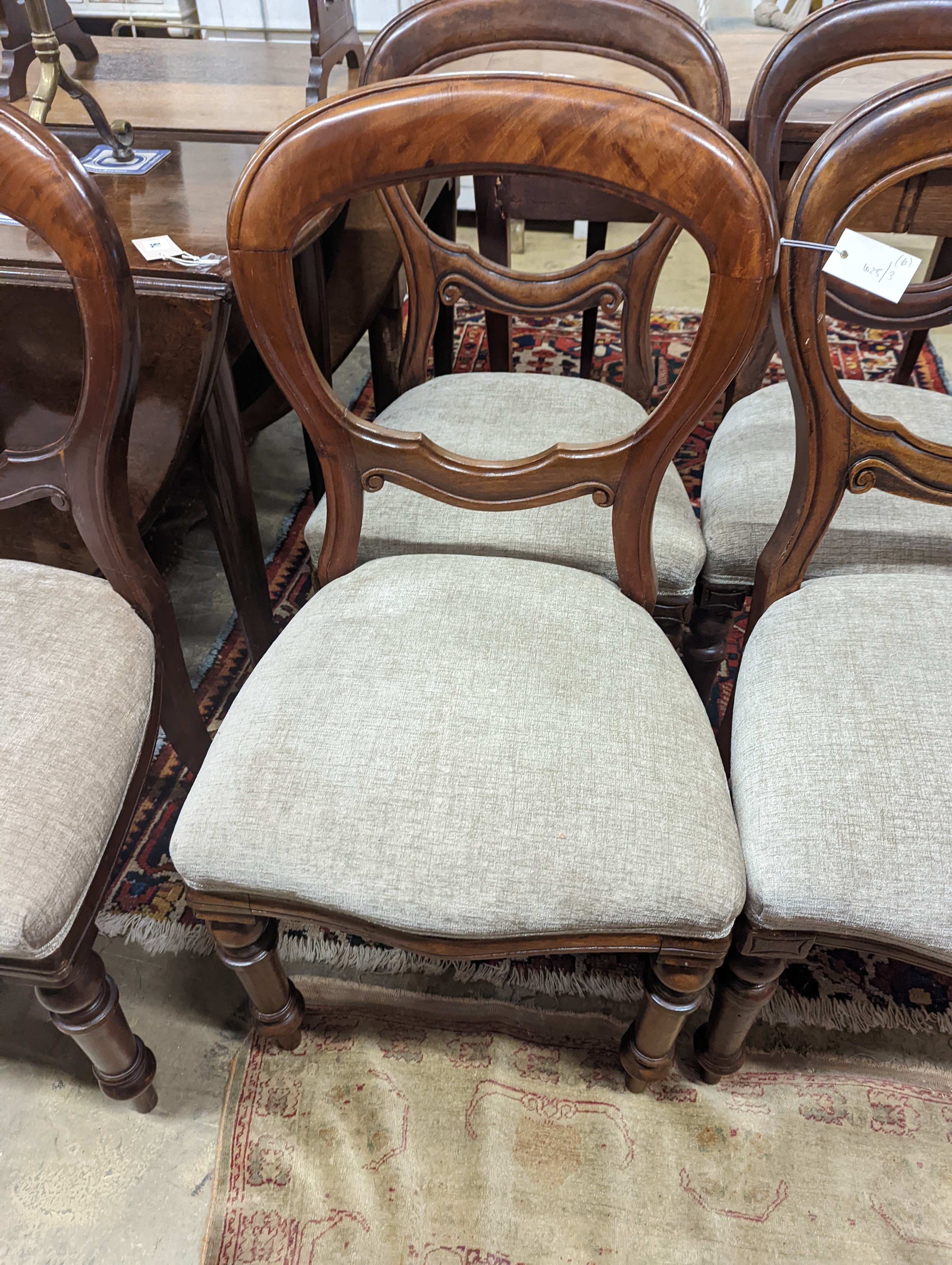 A set of six Victorian balloon back dining chairs